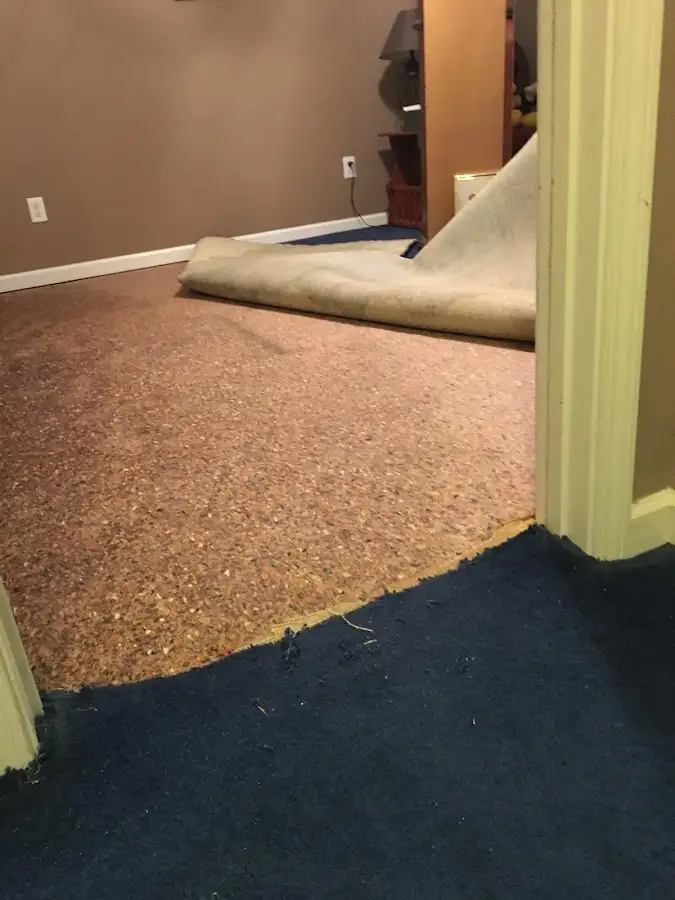 Carpet pad removal revealing water damage during Drying & Dehumidification in Clarinda